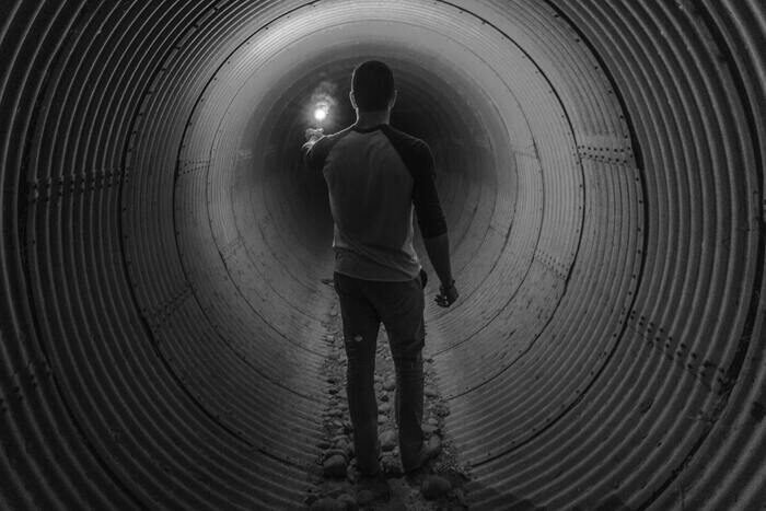Черно-белая фотография парня в тоннеле