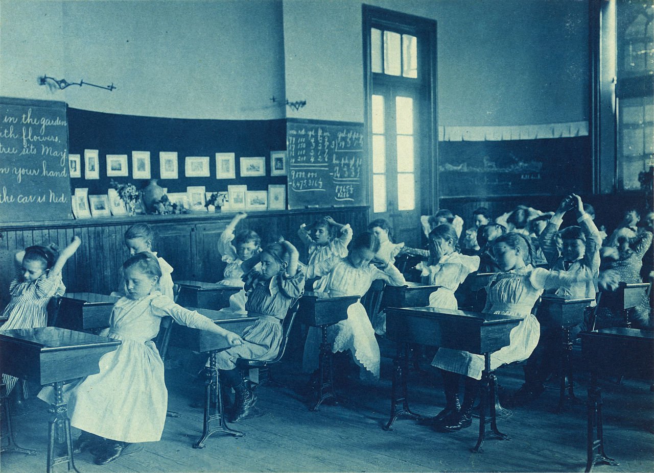 Late 19th century cyanotype photo of schoolgirls doing calisthenics