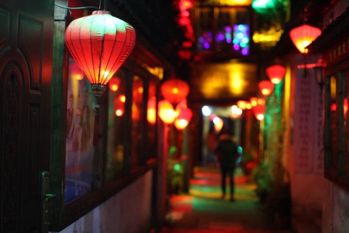 Ночная уличная фотография переулка, освещенного разноцветными фонарями