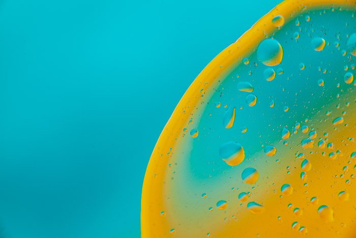 Aqua blue background with the circle of yellow liquid on the right side 