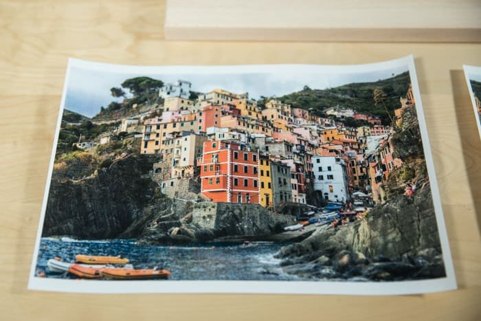 Фотография ярко раскрашенного прибрежного города, покоящегося на деревянной доске