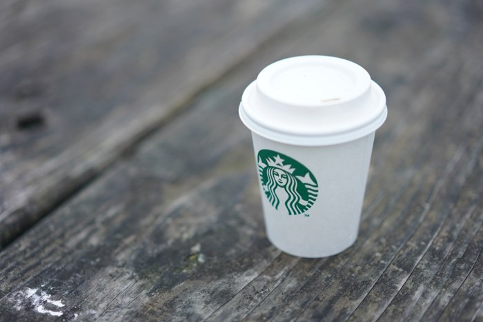 starbucks cup on the grey wood surface