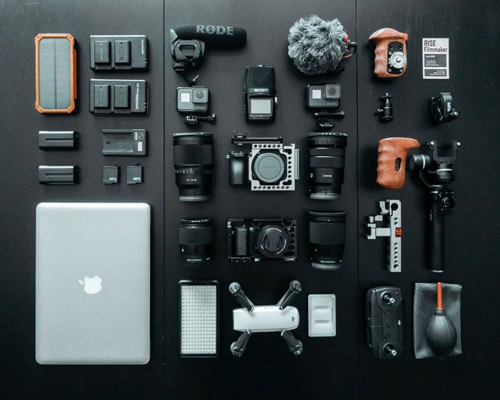 Flat lay photo of various used cameras and camera gear