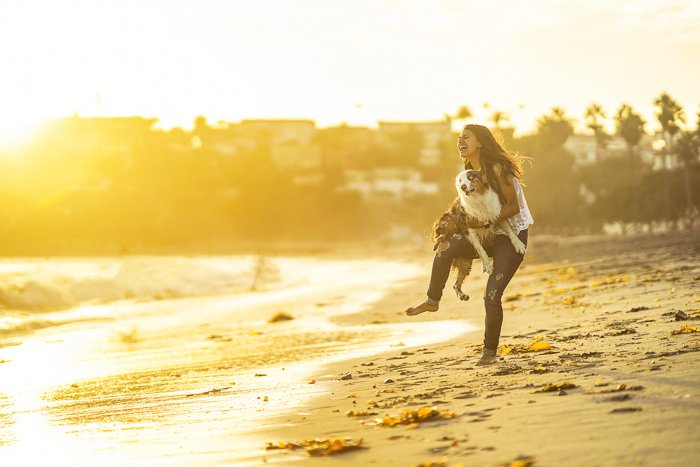 Женщина и маленькая собака на пляже, снятые камерой Sony a7R II