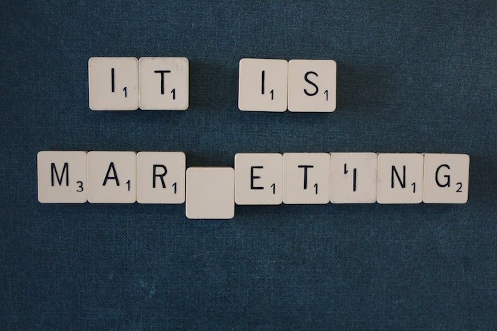 Scrabble letter spelling 'It is marketing'