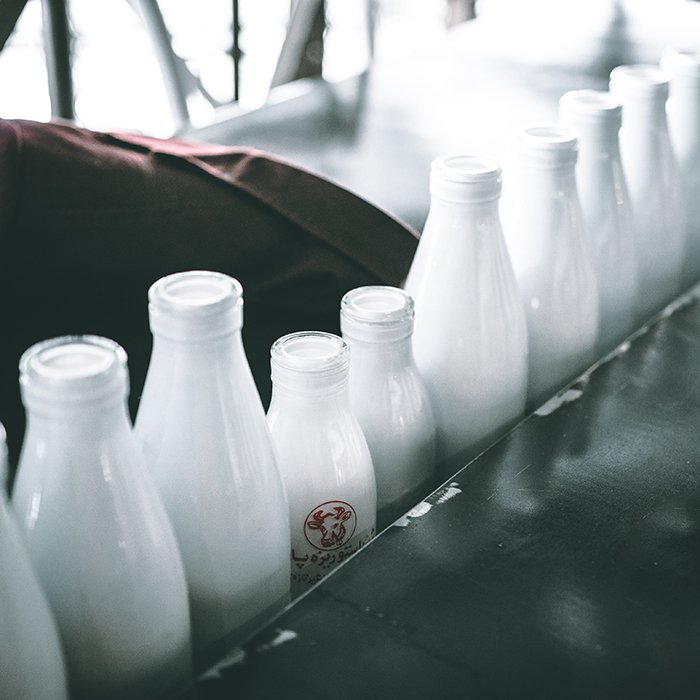 Ряд молочных бутылок разного размера