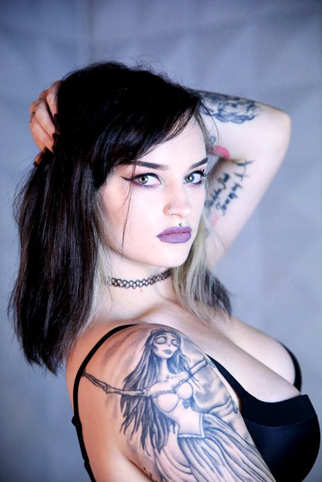 Close up of tattooed female model posing indoors - tattoo photoshoot