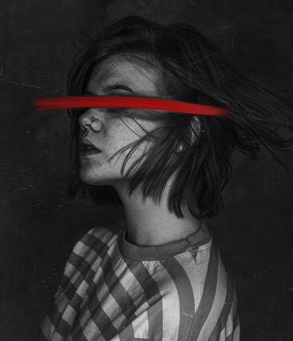 A surreal monotone portrait of a female model featuring a painted red streak over her eyes - conceptual photography ideas