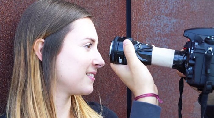 Image of a photographer using a DIY macro lens to shoot the closeup of a women's eyes
