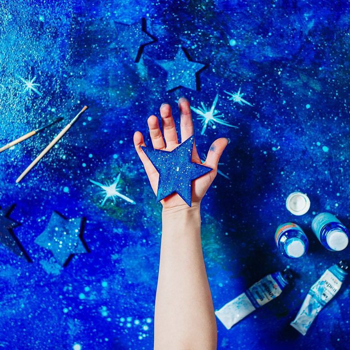 A creative spaced themed photography flat lay on hand painted background 