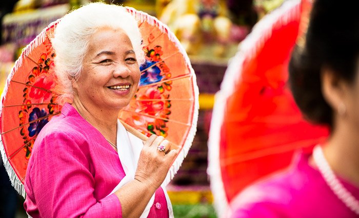 Красочный уличный портрет элегантной пожилой женщины, держащей зонтик - советы по использованию фотографий, которые рассказывают историю