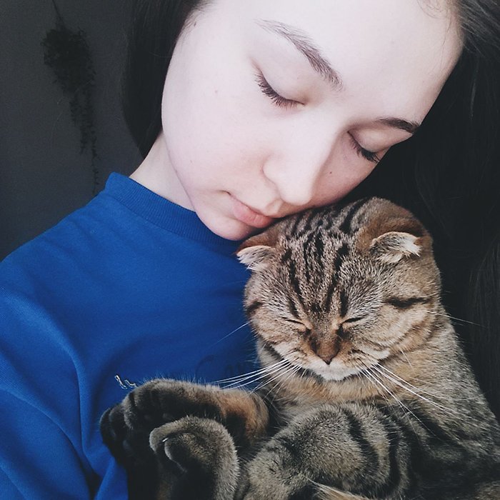Милый портрет женщины-модели, позирующей с кошкой табби - фотосъемка домашних животных на смартфон