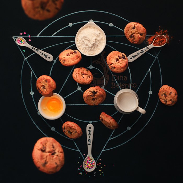 Alchemy themed food flatlay including coffee cups, chalk drawings, sugar sprinkles and cookies