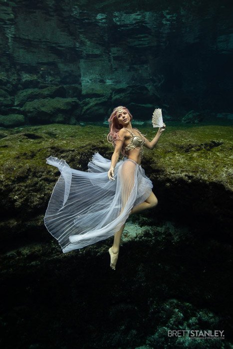 Dreamy underwater portrait of the female model swimming