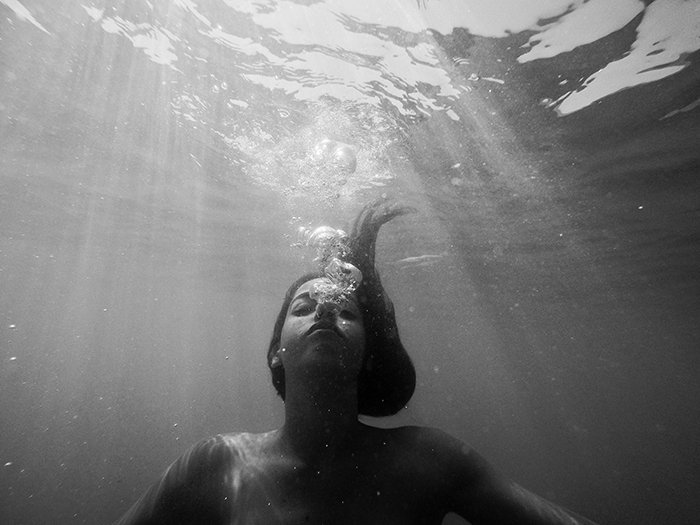 Атмосферное однотонное подводное фото женщины-пловца