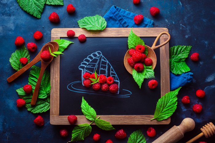 Creative flat lay featuring berries and a chalkboard 