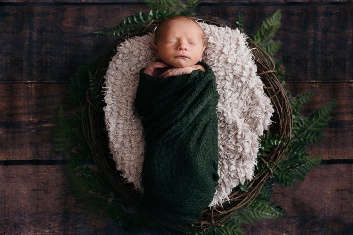 A sweet overhead portrait of baby girl in rustic basket - diy newborn photography