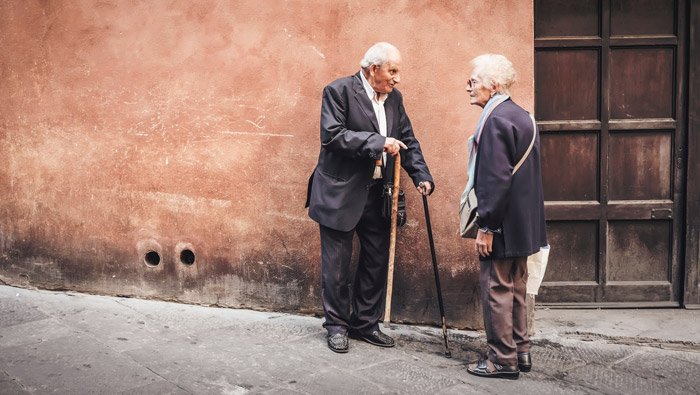 Street portrait of the elderly couple chatting - photography themes