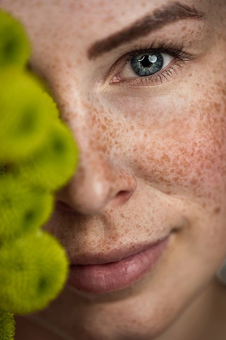 Портретная фотография женщины с веснушками крупным планом