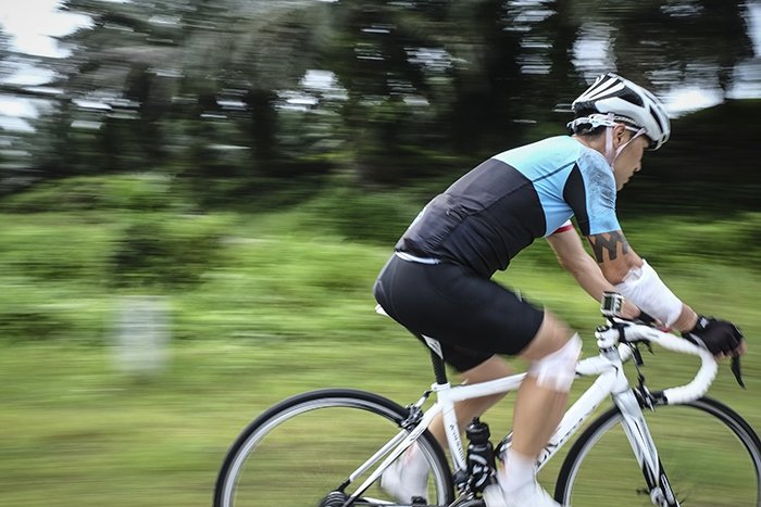 Panning shot of Cyclist Riding Sport Bike