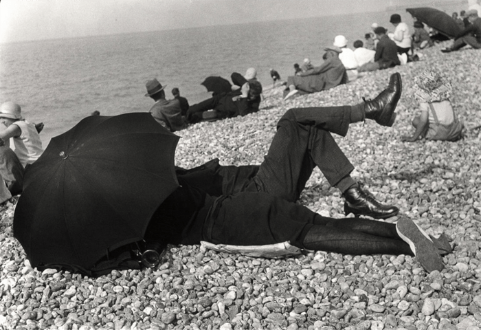 Henri Cartier-Bresson image of the man and woman under an umbrella on the beach