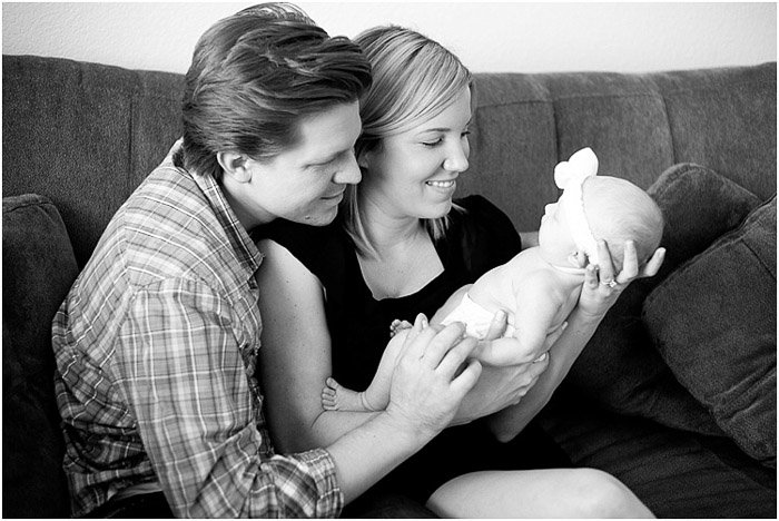 Черно-белые портреты родителей, держащих новорожденного ребенка