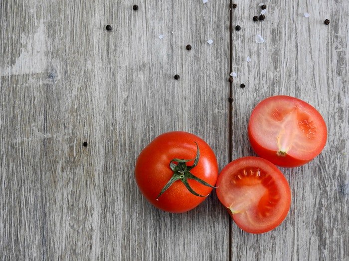цветовой контраст между томатами и деревом помогает создать уравновешенную композицию, которая привлекает внимание